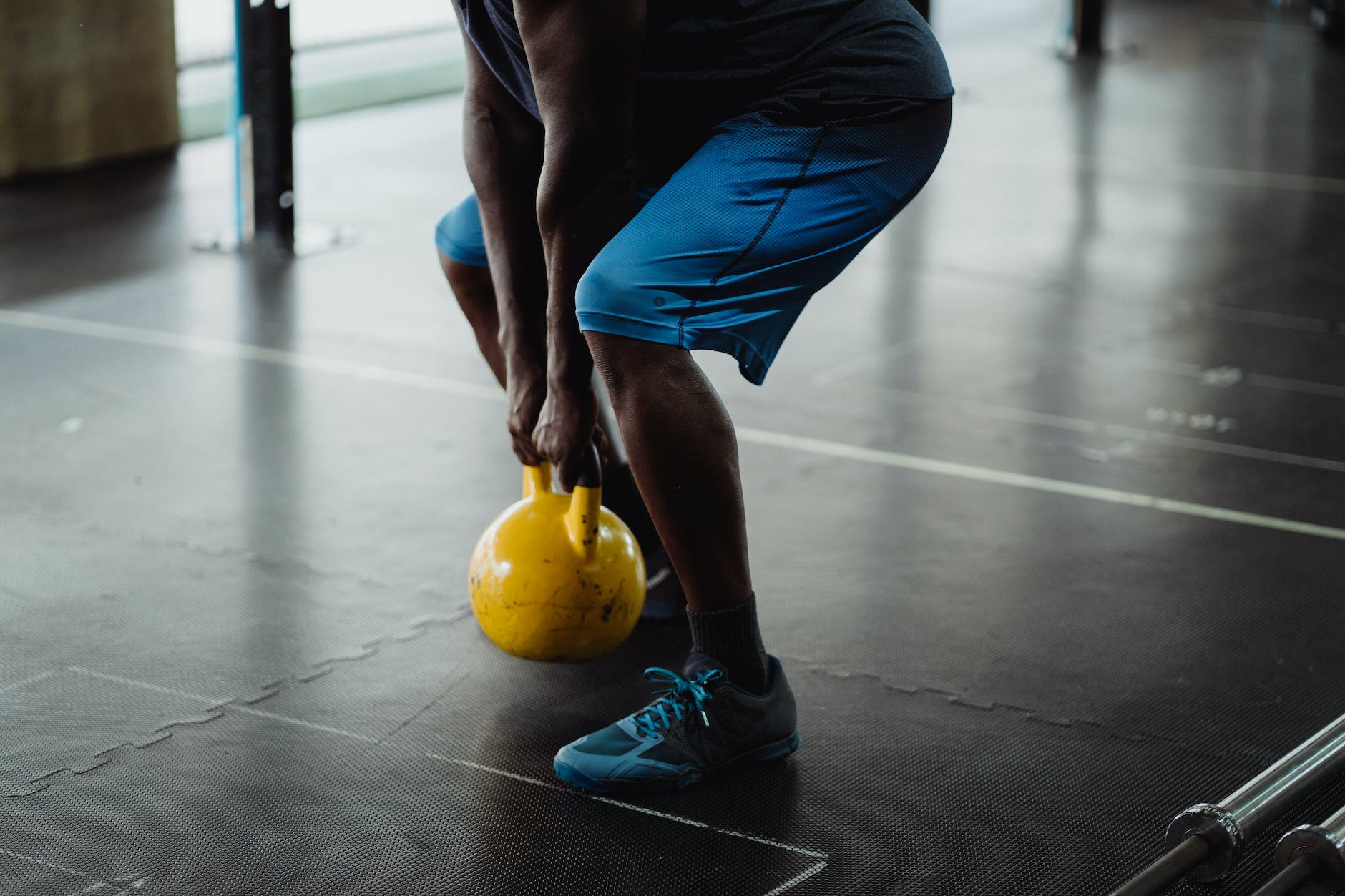 person using yellow kettlebell